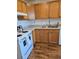 Charming kitchen with oak cabinets, granite countertops, and modern white appliances at 4915 Bay Ne St # 322, St Petersburg, FL 33703