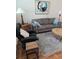 Cozy living room features sofa, armchair, side tables and modern artwork at 4915 Bay Ne St # 322, St Petersburg, FL 33703