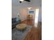 Inviting living room with hardwood floors, table and seating, with views into adjoining room at 4915 Bay Ne St # 322, St Petersburg, FL 33703