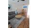 Cozy living room featuring a gray sofa, round glass table, and modern artwork at 4915 Bay Ne St # 322, St Petersburg, FL 33703