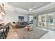 Cozy living room with a gray sofa, stylish rug, view of the pool, and access to the open kitchen at 912 Gulf View Blvd, Dunedin, FL 34698