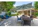 Relaxing backyard patio area with an umbrella table and chairs for outdoor entertaining at 12261 Eldon Dr, Largo, FL 33774