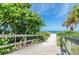 Wooden beach path leading to a picturesque sandy beach and ocean view at 12261 Eldon Dr, Largo, FL 33774