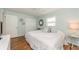 Comfortable bedroom featuring a ceiling fan, window, closet and warm wood flooring at 12261 Eldon Dr, Largo, FL 33774