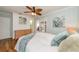 Bedroom featuring aqua walls, warm wood floors, ceiling fan, and sliding glass doors at 12261 Eldon Dr, Largo, FL 33774