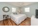 Relaxing bedroom with wood floors, soothing wall color, a ceiling fan, and two windows for natural light at 12261 Eldon Dr, Largo, FL 33774