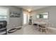 Cozy dining area with a round table, white chairs, and soft natural light filtering through the windows at 12261 Eldon Dr, Largo, FL 33774