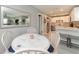 Charming kitchen with stainless steel appliances and a lovely round dining table near the living room at 12261 Eldon Dr, Largo, FL 33774