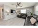 Comfortable living room with a TV, leather sofas, and a ceiling fan, perfect for relaxation at 12261 Eldon Dr, Largo, FL 33774