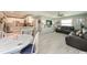 Open-concept living space with modern tile floors, a ceiling fan, and a seamless transition to the kitchen at 12261 Eldon Dr, Largo, FL 33774