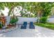 Private backyard patio area with lounge chairs and tropical plants at 12261 Eldon Dr, Largo, FL 33774