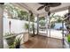 Outdoor screened porch featuring plants, tile flooring, and plenty of space for furniture at 12261 Eldon Dr, Largo, FL 33774
