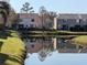 Beautiful lake view showcasing reflections of the townhouses and surrounding landscape at 12287 Country White Cir, Tampa, FL 33635