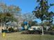 Neighborhood playground featuring a slide, climbing structure, and ride-on toy in a grassy park setting at 12287 Country White Cir, Tampa, FL 33635