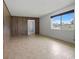 Bright room with tile floors and a large window, complemented by wood paneling and an open doorway at 2103 W Vina Del Mar Blvd, St Pete Beach, FL 33706