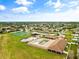 Aerial view of a community pool, playground and tennis court in a residential neighborhood on a sunny day at 2604 Dakota Rock Dr, Ruskin, FL 33570