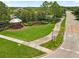 View of the community entrance sign surrounded by green grass, trees and a gazebo at 2604 Dakota Rock Dr, Ruskin, FL 33570