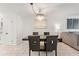 Elegant dining area with a modern chandelier, seating for four, and marble floors at 4400 37Th S St # 3, St Petersburg, FL 33711
