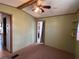 Bedroom featuring a ceiling fan and two doorways at 4747 Bobby Ave # 258, Zephyrhills, FL 33541