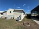 Rear exterior with lawn, satelite dish, and central air at 4747 Bobby Ave # 258, Zephyrhills, FL 33541