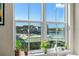 Waterfront view from the window, showing buildings along the waterfront, boats on the water, and plants on the windowsill at 700 S Harbour Island Blvd # 802, Tampa, FL 33602