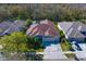 An aerial view of a single-Gathering home with a screened-in pool, mature trees, and well-maintained landscaping at 8205 Prairie Ridge Way, Tampa, FL 33647