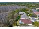 Aerial view showcases homes with screened pools in a lush, wooded community at 8205 Prairie Ridge Way, Tampa, FL 33647