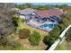 Beautiful in-ground pool with patio area and screened-in enclosure surrounded by lush green landscaping at 8205 Prairie Ridge Way, Tampa, FL 33647