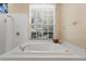 Bathroom with a soaking tub under a window, providing natural light and an airy feel at 8205 Prairie Ridge Way, Tampa, FL 33647