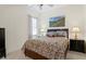 Cozy bedroom with a queen-sized bed, neutral walls, and carpeted floors at 8205 Prairie Ridge Way, Tampa, FL 33647