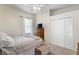 Bright bedroom with a bed, dresser, and closet, offering ample storage and comfort at 8205 Prairie Ridge Way, Tampa, FL 33647