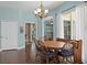 Cozy dining area features wood table and chairs, with views to additional rooms at 8205 Prairie Ridge Way, Tampa, FL 33647