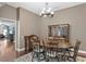 Cozy dining room with hardwood floors, neutral paint, chandelier and doorway to living spaces at 8205 Prairie Ridge Way, Tampa, FL 33647