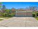 Charming single-story home featuring a three-car garage, lush landscaping, and a well-manicured lawn at 8205 Prairie Ridge Way, Tampa, FL 33647