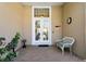 Inviting front porch with brick flooring, double-door entrance, and decorative bench, enhancing curb appeal at 8205 Prairie Ridge Way, Tampa, FL 33647