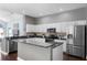 Updated kitchen featuring stainless steel appliances and eat-in island with stone countertops and modern cabinetry at 8205 Prairie Ridge Way, Tampa, FL 33647