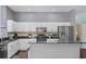 Well-lit kitchen with stainless steel appliances, granite countertops, and ample cabinet space at 8205 Prairie Ridge Way, Tampa, FL 33647