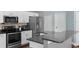 A partial view of the kitchen, showcasing stainless steel appliances and a raised eat-in stone countertop at 8205 Prairie Ridge Way, Tampa, FL 33647