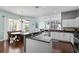 Open floor plan of kitchen, dining, and living areas; island overlooks dining and living spaces at 8205 Prairie Ridge Way, Tampa, FL 33647