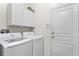 Laundry room equipped with a modern washer and dryer, providing convenience for chores at 8205 Prairie Ridge Way, Tampa, FL 33647