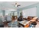 Open-concept living area with hardwood floors, a patterned rug, and views of the dining area at 8205 Prairie Ridge Way, Tampa, FL 33647