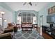 Bright and open living room featuring a large window, ceiling fan, and a cozy seating area at 8205 Prairie Ridge Way, Tampa, FL 33647