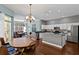 Bright open-concept space with kitchen island overlooking dining area and living room at 8205 Prairie Ridge Way, Tampa, FL 33647