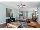Spacious living area with hardwood floors, leather furniture, and open layout to dining space at 8205 Prairie Ridge Way, Tampa, FL 33647