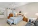 Bright main bedroom featuring a sitting area, natural light, a ceiling fan, and neutral color scheme at 8205 Prairie Ridge Way, Tampa, FL 33647