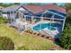 The large private screened-in pool features mature landscaping and is perfect for entertaining or relaxing at 8205 Prairie Ridge Way, Tampa, FL 33647