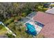 The backyard features a sparkling in-ground pool with screened-in enclosure for privacy and safety at 8205 Prairie Ridge Way, Tampa, FL 33647