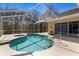 Beautiful screened-in pool with spa, providing a serene outdoor oasis for relaxation and enjoyment at 8205 Prairie Ridge Way, Tampa, FL 33647