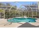 Sparkling screened-in pool and spa offer a private and refreshing outdoor retreat surrounded by lush landscaping at 8205 Prairie Ridge Way, Tampa, FL 33647