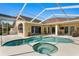 Stunning screened-in pool and spa complemented by a spacious patio, perfect for outdoor gatherings at 8205 Prairie Ridge Way, Tampa, FL 33647